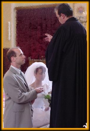 Bride and groom before the priest